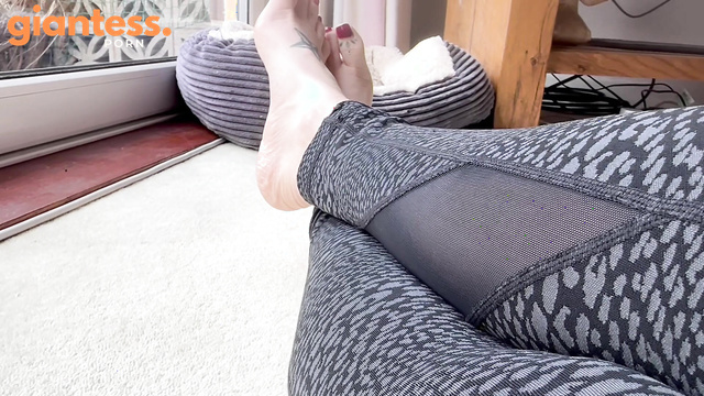 Perfectly Polished Red Toenails And a Tiny Fan on Her Finger
