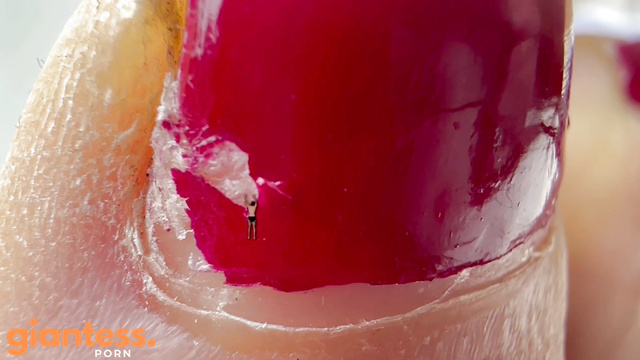 Perfectly Polished Red Toenails And a Tiny Fan on Her Finger